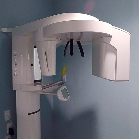 3D cone beam imaging machine standing against a wall